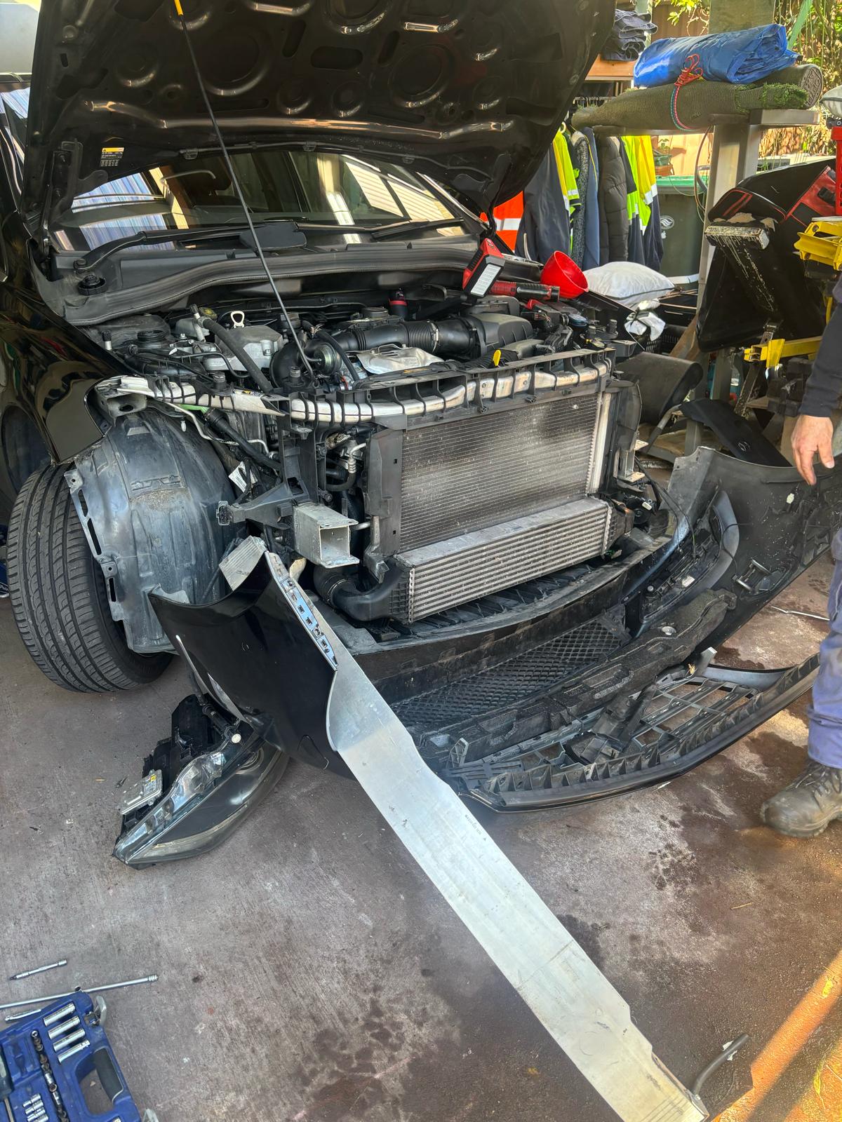 Arthur Tarakjian of North Shore Radiators installing new radiator in Mercedes Benz AMG 